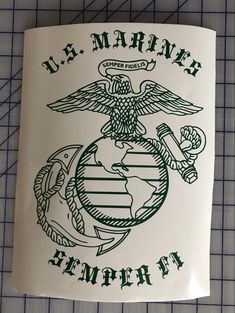 the u s marine emblem is on top of a white paper with green lettering and an eagle