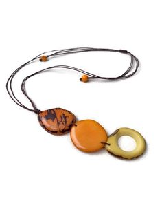 Ecuadorean Tagua Jewelry - Eco Friendly Color: Orange Item Number: TAG644 Necklace Length: 38 inches long About Tagua This Product is handcrafted from a palm tree nut native to the lush tropical rainforests of Ecuador. Also referred to as the Ecuadorean Ivory Palm, the Tagua tree produces several bushels of seed pods a year with up to 100 Tagua nuts per pod. These nuts are then harvested, dried, and crafted into a wide range of products from vibrant modern jewelry, ornate figurines, to everyday Adjustable Yellow Lariat Necklace, Adjustable Cream Necklace, Vintage Beige Adjustable Necklace, Vintage Adjustable Beige Necklace, Adjustable Vintage Beige Necklace, Beige Long Necklace For The Beach, Handmade Beige Long Necklace, Brown Lariat Necklace For Beach, Handmade Long Beige Necklace