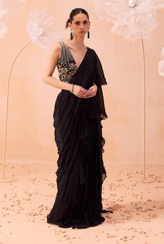 Make a striking impression with this black ruffle sari, beautifully paired with an all-gold blouse featuring exquisite hand-embroidered floral and tonal zardozi work. This elegant combination merges contemporary style with traditional artistry, perfect for any sophisticated occasion. Black Ruffle Saree, Designer Party Wear Saree, Maharani Designer Boutique, Modern Bridal Gowns, Blouse Satin, Zardozi Work, Ruffle Saree, Vacuum Storage, Party Wear Saree