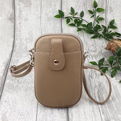 This Italian leather crossbody phone pouch is perfect for those who like a small bag and the latest accessory styles. It has 2 compartments - one is a zip fastening to help keep your essentials safe and the other is a magnetic stud fastening and can be worn crossbody or over-shoulder as it has an adjustable leather strap. Please see the VIDEO which will hopefully give you an idea of the true colour of the phone bag. Full Description / Specification: * Silver colour hardware *Top zip closure * Co Iphone Purse, Leather Phone Bag, Artisan Bag, Brown Crossbody, Travel Purse, Phone Pouch, Silver Colour, Phone Wallet, Leather Pouch