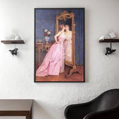 a painting hanging on the wall next to a chair