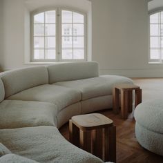 a living room filled with furniture and windows