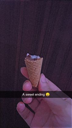 someone is holding an ice cream cone in their left hand with the word sweet ending on it