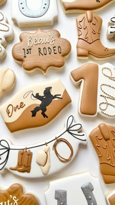 decorated cookies are arranged in the shape of cowboy boots, boots and horseshoes with words on them