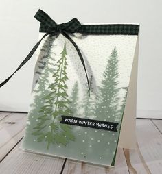 a card with trees on it and the words warm winter wishes