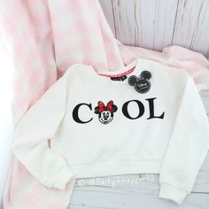 This Cropped Sweatshirt Features A "Cool" Graphic On The Front W/ One Of The "O's" Detailed As A Sequin Minnie Mouse. The Inside Neck Has Minnie Mouse And Hearts Logo Tape Running Across The Back. This Simple Sweatshirt Has All The Little Details In Mind. The Inside Of This Sweatshirt Is A Buttery Soft Brushed Texture. 65% Polyester, 35% Cotton. Disney X Primark All Orders Are Packaged With And Are Shipped Out Asap! Questions? Leave Us A Comment! We Are More Than Happy To Help! New To Poshmark? Cute Mickey Mouse Cotton Sweatshirt, Playful White Sweatshirt With Character Print, Cute White Mickey Mouse Sweatshirt, White Cotton Mickey Mouse Sweatshirt, Casual White Mickey Mouse Sweatshirt, White Long Sleeve Mickey Mouse Sweatshirt, White Long Sleeve Sweatshirt With Mickey Mouse, White Mickey Mouse Sweatshirt For Winter, White Mickey Mouse Winter Sweatshirt