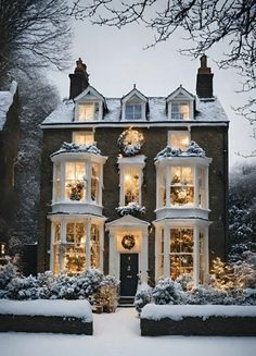 a large house covered in snow with christmas lights