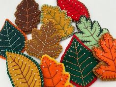 small autumn leaf appliques are shown in various colors and sizes, including green, red, yellow, orange, and brown