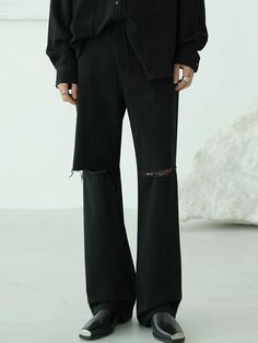 These are pants with a striking straight fit, featuring large rips at the knees. It has a long length for versatile styling.- High rise design to add appeal to the item- Versatile item that can be styled with any top- Clean button and fastening for a polished look Black Ripped Wide Leg Pants, Black Ripped Wide Leg Jeans, Fall Streetwear Jeans With Holes, Casual Black Ripped Flare Jeans, Black Ripped Straight Leg Pants, Straight Leg Jeans With Holes For Fall, Edgy Straight Leg Bottoms With Holes, Black Ripped Flare Jeans For Fall, Cotton Jeans With Holes For Fall