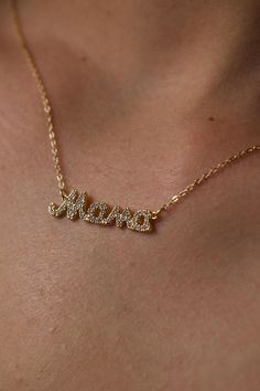 Celebrate the special bond of motherhood with our 14k Gold Filled Diamond Mama Necklace. Featuring a delicate "Mama" script adorned with sparkling cubic zirconia, this necklace adds both elegance and sentiment to any outfit. Its timeless design is perfect for layering or wearing on its own, making it a versatile accessory for any occasion. **Material 14k gold filled with cubic zirconia   **Length 17 inches with extender   **Closure Lobster clasp   **Hypoallergenic Safe for sensitive skin, nickel-free   Ideal for Mother's Day, baby showers, or simply showing appreciation for mom, this Diamond Mama Necklace is a meaningful and stylish gift. Whether for casual wear or formal events, it makes a beautiful present for special occasions like Christmas, Valentine's Day, birthdays, and anniversarie Dainty Necklace Diamond, Gold Dainty Necklace, Script Necklace, Mama Necklace, Pendant Necklace Gold, Diamond Jewelry Necklace, Necklace Diamond, Dainty Gold Necklace, Perfect Gift For Mom