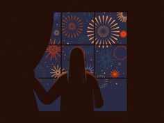 a person standing in front of a window with fireworks