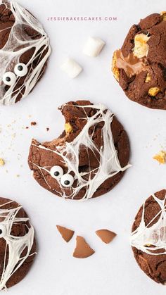 chocolate cookies decorated with white icing and googly eyes