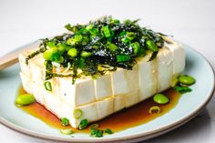 tofu with green vegetables and sauce on a plate