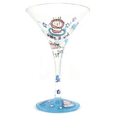 a wine glass with a clock and stars painted on the bottom, sitting in front of a white background