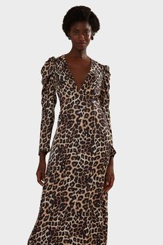 The Natural Skin Cream Midi Dress is a stunning silhouette in a playful leopard print. This animal print midi dress elegantly balances a deep v neckline with a gently ruched puff sleeve. The bodice is expertly tailored to flatter the feminine form with pristinely placed darts that flow to a midi length skirt. Dress it up with a chic heel for an upscale event or keep it cool with a boot and minimalist gold jewelry.Since 1997, FARM Rio has been creating joyful garments based on good energy and bea Cream Midi Dress, Gold Minimalist Jewelry, Lead By Example, Chic Heels, Denim Outerwear, Denim Sweater, Midi Length Skirts, Skin Cream, Organic Fabrics