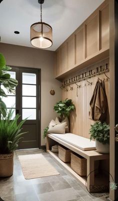 a hallway with a bench, potted plants and hanging hooks