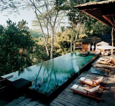 an outdoor swimming pool surrounded by trees