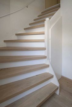 the stairs are made of wood and white paint