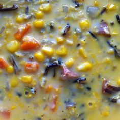 a yellow bowl filled with corn and carrots