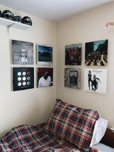 a bed sitting in a bedroom next to a wall with pictures on it