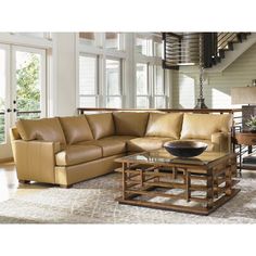 a living room filled with furniture and lots of windows