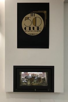 two black and gold signs hanging on the wall next to each other in a room