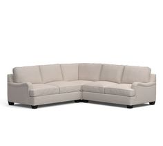 a white sectional couch sitting on top of a white floor