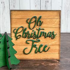 a wooden sign that says oh christmas tree next to a cutout of a small fir tree