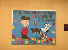 there is a sign on the wall that says it's thanksgiving charlie brown and his dog