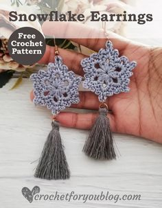 the snowflake earrings are crocheted with tassels