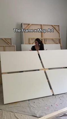 the frame x mop art project is being worked on by a woman in black shirt