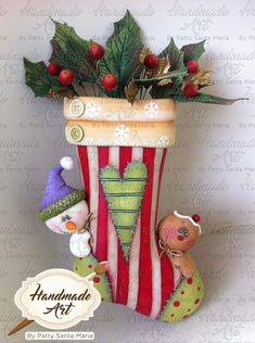 a red and white striped vase filled with christmas decorations