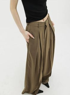 Infuse elegance into your wardrobe with our Wide Leg Criss-Cross Pleated Palazzo Trousers, a harmonious blend of comfort and chic.
Crafted with attention to detail, these trousers feature a high-waist cut for a flattering silhouette and come in a timeless black shade. Asymmetrical pleats add a touch of uniqueness, while the fluid fabric encapsulates a modern, commute-friendly vibe. They're perfect for both a professional setting and casual outings.
Pair them with a fitted blouse for work or a re Chic Brown Bottoms For The Office, Chic Brown Office Bottoms, Baggy Ankle-length Business Casual Bottoms, Chic Wide Leg Baggy Dress Pants, Chic Baggy Wide Leg Dress Pants, Elegant Loose Fit Wide Leg Pants For Spring, Elegant High Waist Baggy Pants, Elegant Brown Bottoms With Pockets, Chic Baggy Bottoms For Workwear