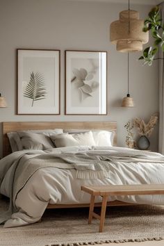 a bedroom with two pictures hanging above the bed