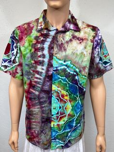 Iced tie dye, large sized men's button shirt. This shirt is 55% linen and 45% cotton midweight, great for summer festivals. Is machine wash and dry with dark colors. Has button front, and short sleeves, has a front pocket. Has HUGE mandala on back, one on right sleeve, half mandala on front and on left sleeve. Live music is coming back, this is the shirt for you! Measurements are garment laid out flat  23 inches from armpit to armpit across the front  29 inches from center of shoulder to bottom hem down front  17 inches from collar at shoulder across and down sleeve to bottom Pre-washed Short Sleeve Tops For Summer, Short Sleeve Tie Dye Shirt For Summer, Tie Dye Short Sleeve Shirt For Summer, Summer Tie-dye Cotton Shirt, Summer Bohemian Camp Shirt With Camp Collar, Multicolor Shirt For Summer Festival, Multicolor Short Sleeve Shirt For Festival, Bohemian Cotton Camp Shirt For Beach, Bohemian Green Short Sleeve Shirt