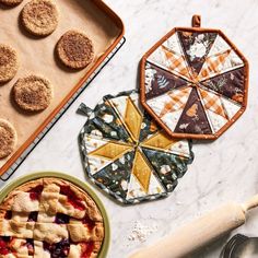 two pies and some cookies on a table