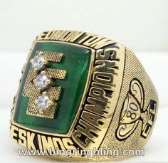 a green and gold ring sitting on top of a table