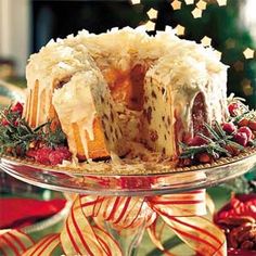 a christmas cake on a glass platter with candy canes