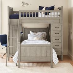 a bunk bed with drawers underneath it and a ladder to the bottom that leads up