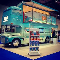 a blue double decker bus is on display