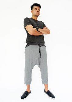 "🚚..ALL ORDERS ARE SHIPPED VIA DHL EXPRESS MAIL Harem-style sweatpants with a cropped profile. Made of stretch cotton-blend jersey, these cropped pants are comfortable to wear and easy to move in. * Pull-on style * Drop-crotch style * Elastic waistband with black drawstring * Side slant pockets * Ribbed ankle cuffs * Cropped length Measurements approximately: Waist: 27\" (68.5 cm) stretching to 48\" (122 cm) Hips: 50\" (127 cm) Outseam: 31\" (79 cm) In Front Rise: 17 1/2\" (44 cm) In Back Rise: Baggy Sweatpants With Hip Pockets, Cotton Drop Crotch Bottoms For Streetwear, Gray Hip Hop Long Pants, Casual Parachute Pants With Drop Crotch And Pockets, Cotton Drop Crotch Streetwear Pants, Gray Tapered Leg Streetwear Bottoms, Casual Drop Crotch Parachute Pants With Pockets, Streetwear Cotton Drop Crotch Pants, Relaxed Fit Drop Crotch Pants With Side Pockets