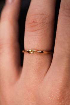 The Möbius Band features a continuous wave design that embodies unity and infinity. The ring is handcrafted out of a D-shaped (half round) metal, featuring a single ribbon-like wave. This listing is for ONE single ring in  14K Gold Fill. The thickness of the metal used with this ring measures approximately 2mm which gives this piece a durable and sturdy design while maintaining that effortless look. While this ring is gorgeous on its own, we think it makes a lovely stack when combined with the Minimalist Twisted Jewelry For Anniversary, Modern Wavy Jewelry For Anniversary, Twisted 14k Gold Rings With Modern Twist, Modern Twist Formal Jewelry With Twisted Shape, Modern Twist 14k Gold Twisted Ring, Modern Jewelry For Anniversary, Modern Twisted Jewelry For Formal Occasions, Modern Twist Twisted Jewelry For Formal Occasions, Curved 14k Gold Jewelry For Anniversary