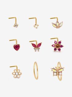 six pairs of gold nose rings with different colored stones and butterfly designs on them, all in various shapes and sizes