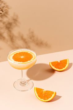 an orange slice sitting on top of a glass filled with liquid