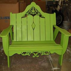 a green wooden bench sitting on top of a floor