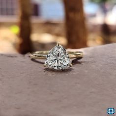 a diamond ring sitting on top of a stone