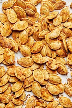 roasted pumpkin seeds on a baking sheet ready to be baked in the oven or used as an appetizer