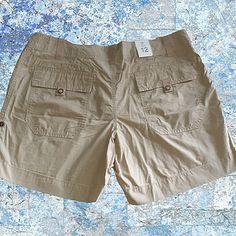 100% Cotton 7" Inseam Before Rolling Up 17.5" Waist Front Pockets Back Snap Flap Pockets Khaki Color Gap Short Bottoms With Pockets, Gap Shorts With Pockets, Gap Bottoms With Pockets, Short Style, Khaki Nylon Shorts With Side Pockets, Khaki Cotton Utility Shorts, Khaki Bottoms With Built-in Shorts, Gap Bottoms With Pockets, Short, Gap Denim Shorts, Black Chino Shorts