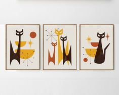 three framed art prints with cats on them