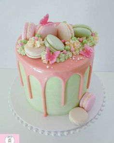 a pink and green cake with flowers on top is shown in the instagramr